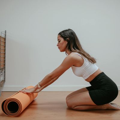 Rolled yoga mat on a clean floor