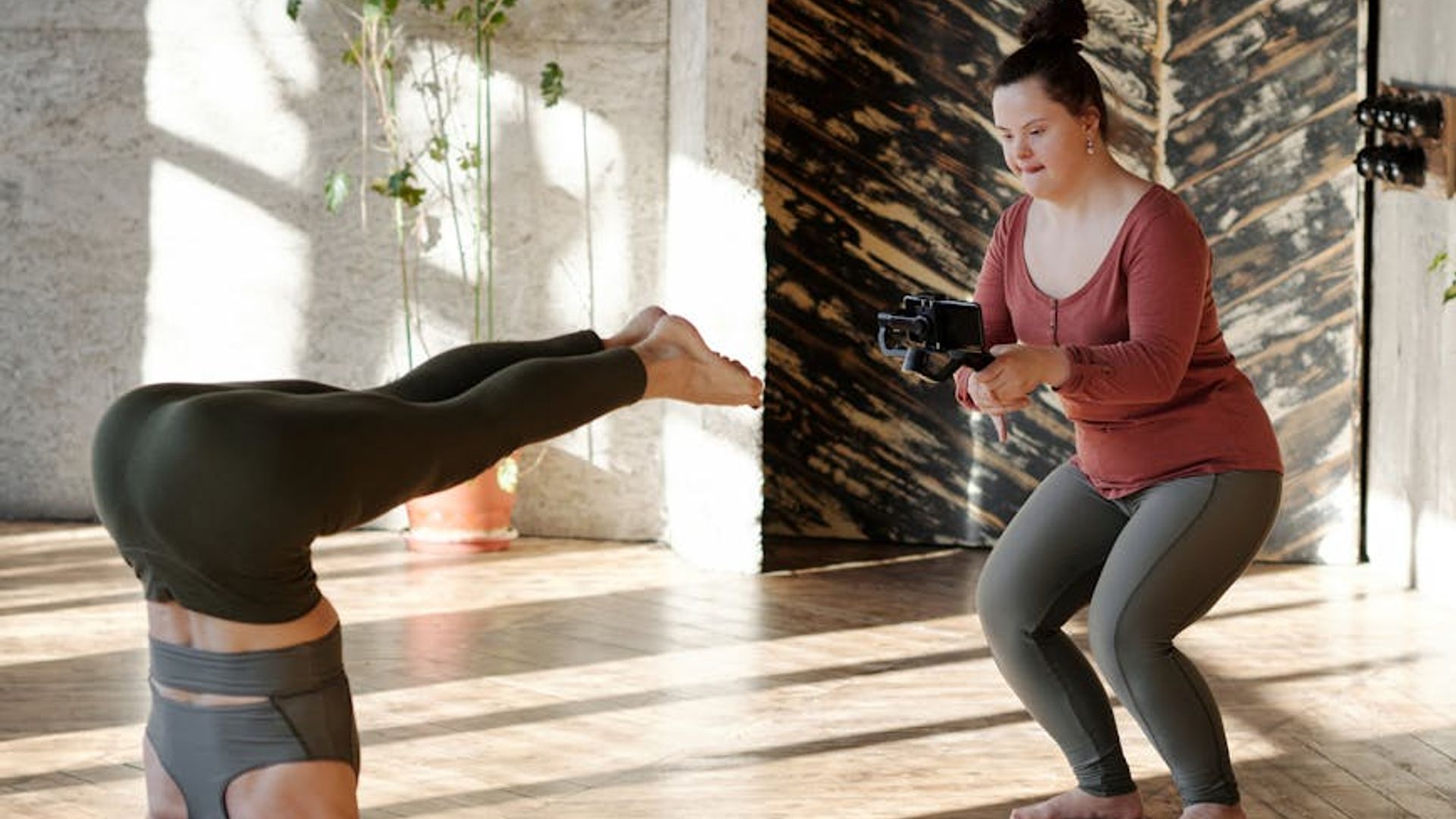Serene yoga studio with natural sunlight and wooden floor